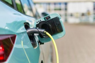 electric car in the parking lot, connected to a charging station