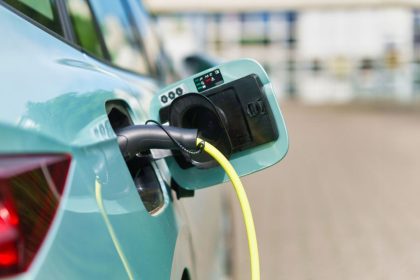 electric car in the parking lot, connected to a charging station